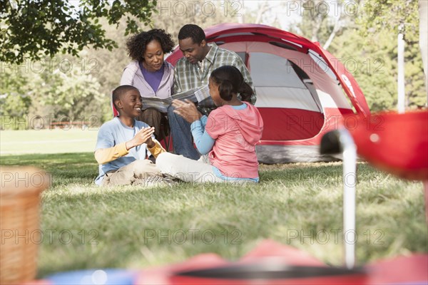 Family relaxing together at campsite