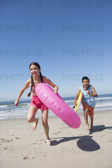 Hispanic children playing on beach