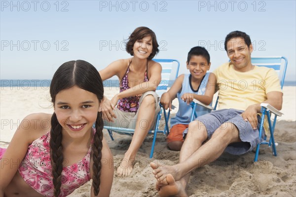 Family smiling together on beach