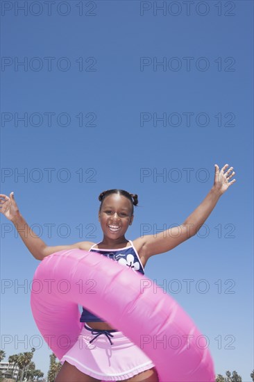 African American girl playing with inner tube