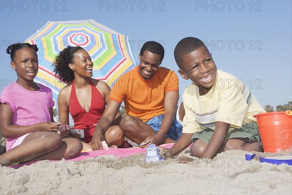 Family relaxing together on beach