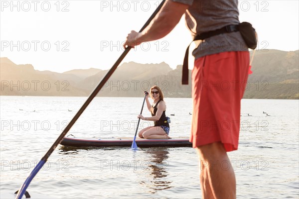Couple on paddleboards in river