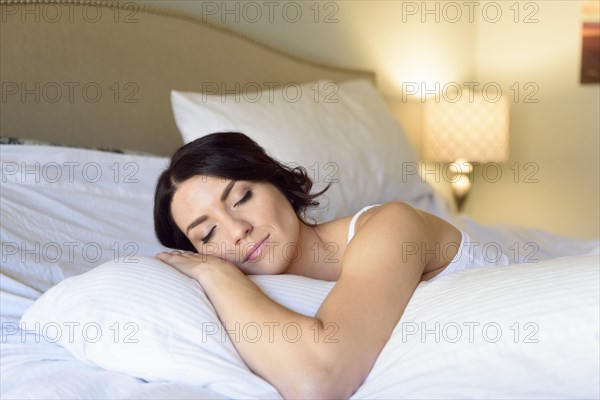 Caucasian woman sleeping on bed