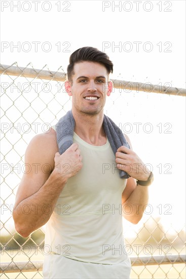 Portrait of Caucasian man resting with towel outdoors