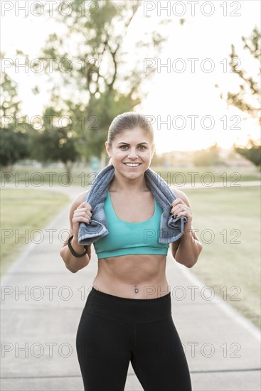 Portrait of Hispanic woman resting with towel outdoors