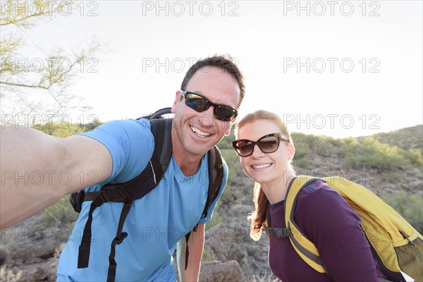 Hikers posing for cell phone selfie