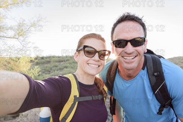 Hikers posing for cell phone selfie