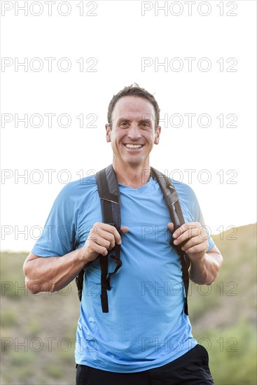 Hispanic hiker wearing backpack