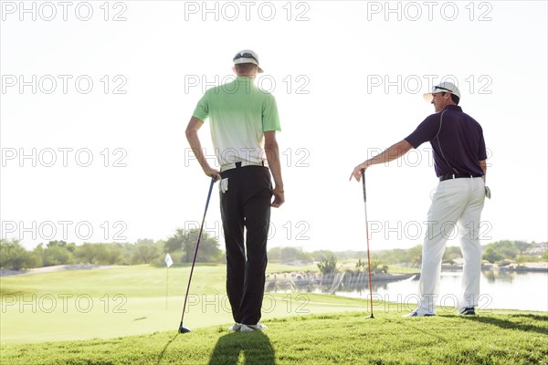 Friends talking on golf course