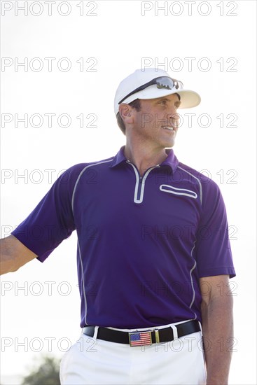 Portrait of Hispanic man wearing American flag belt buckle