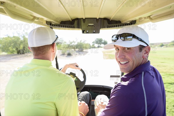 Friends driving on golf course