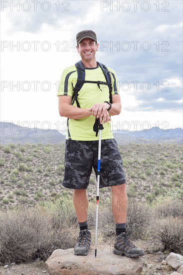 Portrait of smiling Hispanic man hiking in desert