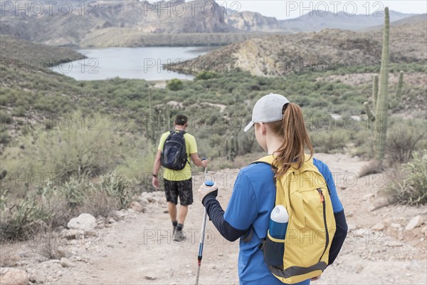 Couple hiking on rocky path in desert