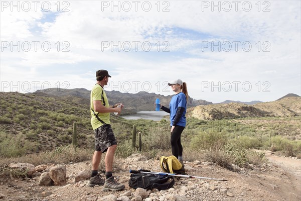 Couple resting while hiking in desert