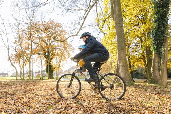 Caucasian father and son riding bicycle