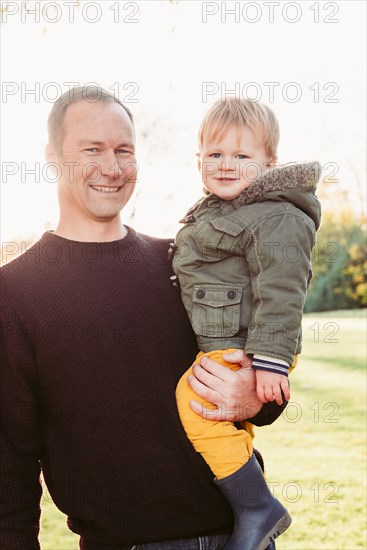 Portrait of Caucasian father posing with son