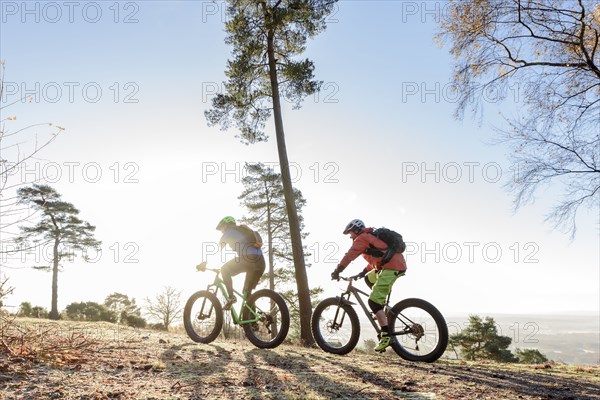 Caucasian couple riding bicycles