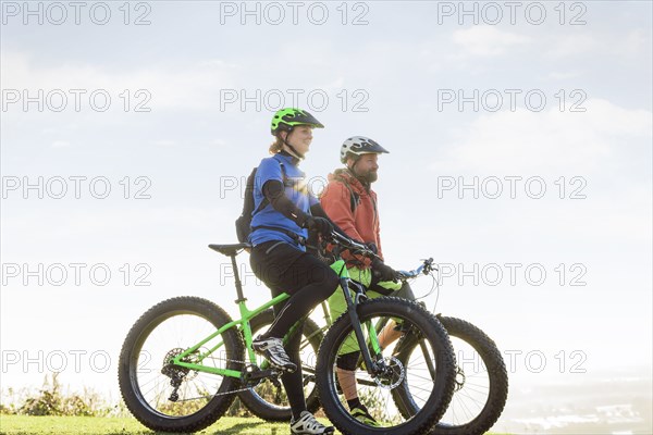 Caucasian couple riding bicycles