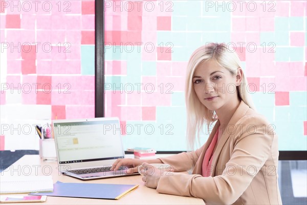 Creative Caucasian businesswoman using laptop