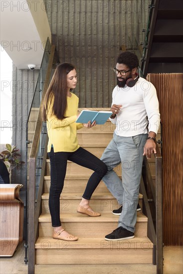 Creative business people talking on staircase