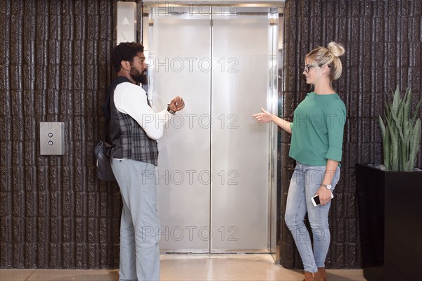 Man and woman waiting for elevator