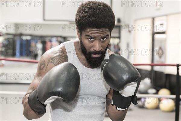 Black man posing in boxing ring