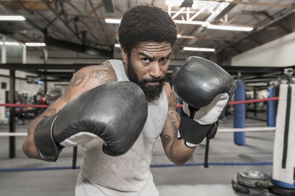 Black man posing in boxing ring