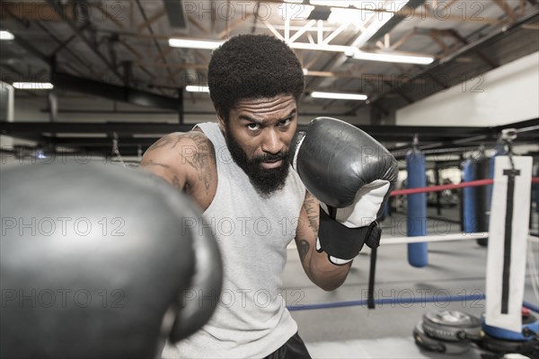 Black man posing in boxing ring