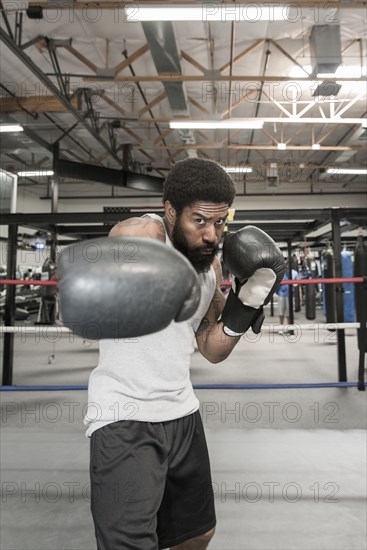 Black man posing in boxing ring