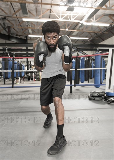 Black man posing in boxing ring