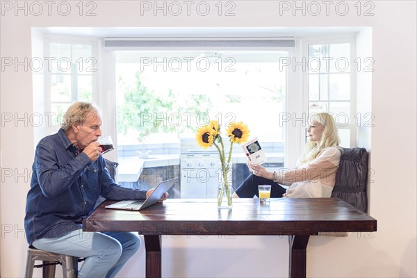 Caucasian couple relaxing near window