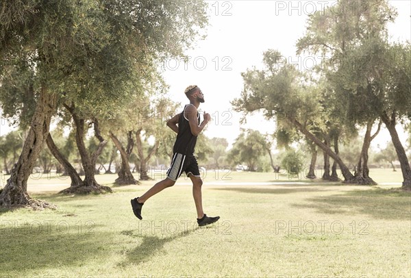 Black man running in park