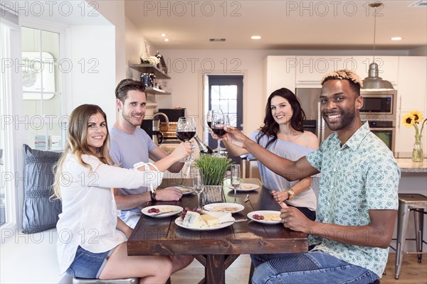 Portrait of friends toasting with red wine