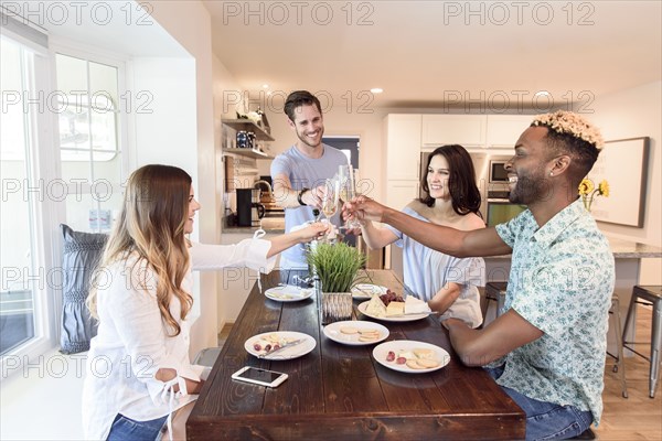 Friends toasting with champagne at table