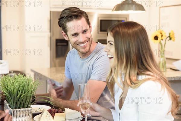 Caucasian couple drinking champagne and laughing