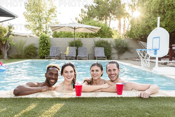 Portrait of smiling friends in swimming pool