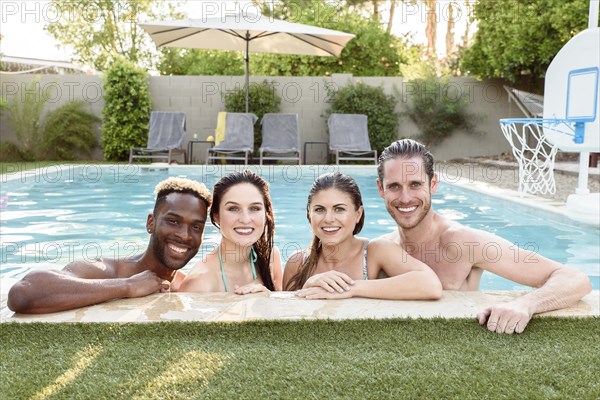 Portrait of smiling friends in swimming pool