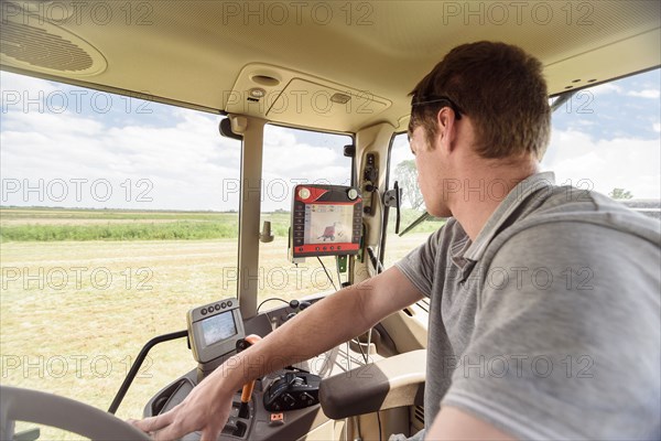 Caucasian man driving tractor on farm