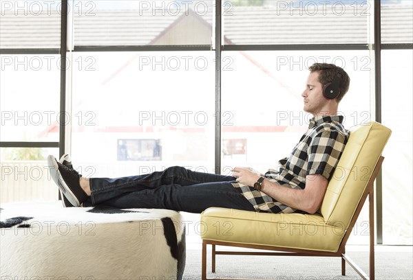 Caucasian man relaxing and listening to headphones