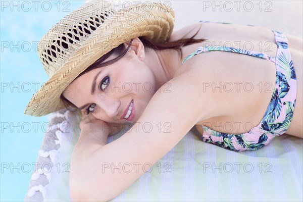 Close up of Caucasian woman laying near swimming pool