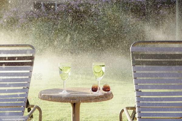 Water spraying on drinks and lounge chairs