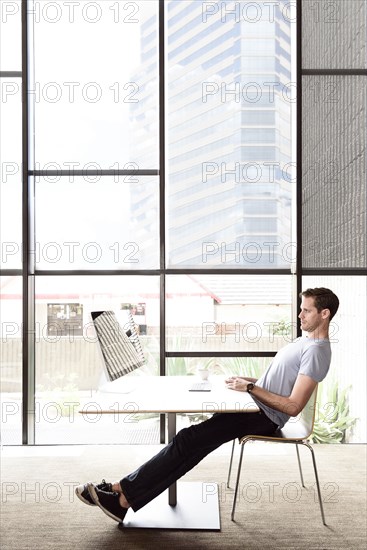 Pensive Caucasian man staring at computer