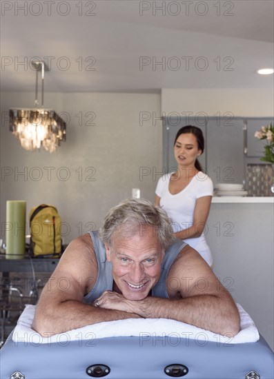 Physical therapist massaging man