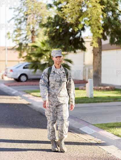 Black woman soldier walking in street