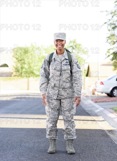 Portrait of black woman soldier standing in street