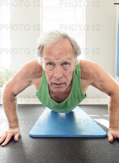 Serious Caucasian man doing push-ups