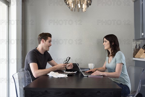 Caucasian man talking to woman with laptop