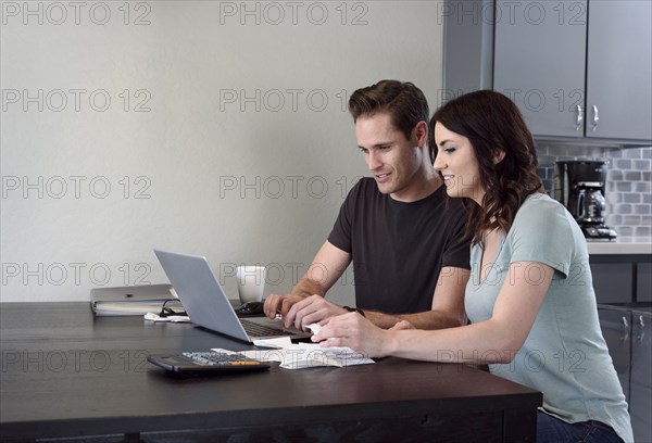 Caucasian couple using laptop