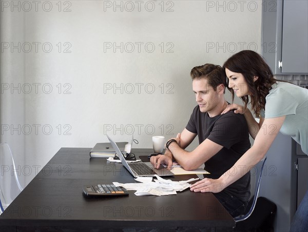 Caucasian couple using laptop