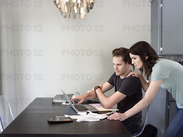 Caucasian couple using laptop